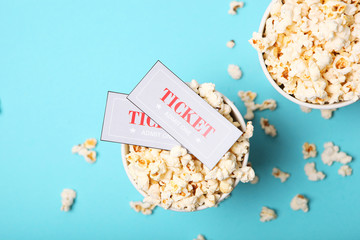 popcorn and movie tickets on a colored background