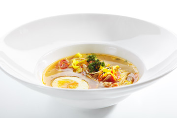Chicken Soup with Tagliatelle Pasta, Eggs and Fresh Herbs Isolated