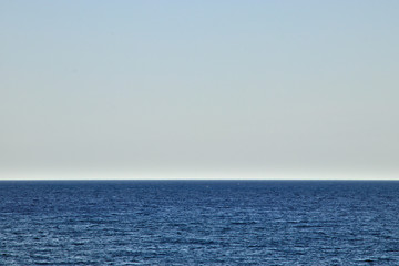 Horizon with blue sky over blue water