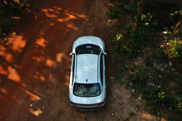 Close up of top view of a white Indian car standing in a forest in the district of Bankura, West Bengal, India