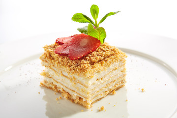 Traditional Russian Honey Cake Medovik on Restaurant Plate Isolated