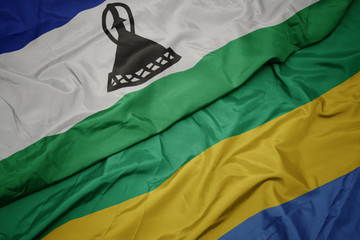 waving colorful flag of gabon and national flag of lesotho.