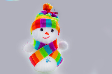 on white background. snowman and scarf in the form of an LGBT flag