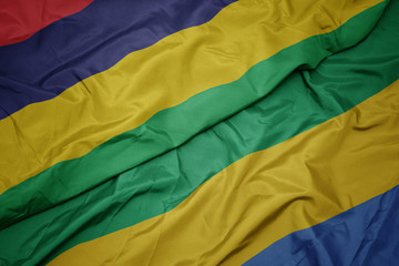 waving colorful flag of gabon and national flag of mauritius.