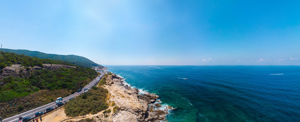 Beautiful wide panorama, aerial view of the public beach, a place to relax, people sunbathe, boats go on the water, copy space. Mediterranena coast in Livorno, Tuscany, Italy