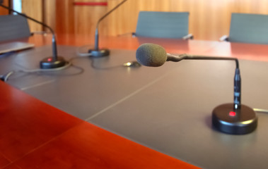 microphone on a wooden table of a boardroom