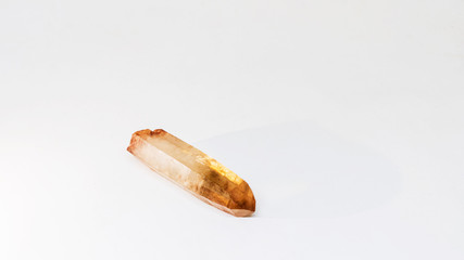 Smokey Quartz Polished Crystal Point lying down on white background. Isolated concept.