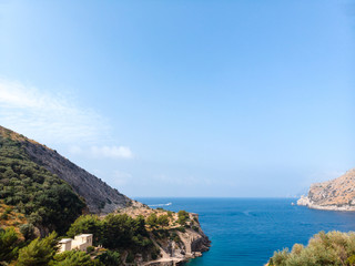 Beautiful aerial view of mountains and sea on sunrise. Marine Park. Trail for active sports, hiking along the mountain to a wild beach, tourist destination. Nerano, Massa Lubrense, Ieranto bay, Italy