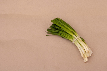 Spring onions, green onions or scallions on wood background
