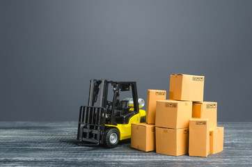 Yellow Forklift truck and cardboard boxes. Transportation logistics infrastructure, import and export goods and products delivery. Production, transport, cargo storage. Freight shipping. retail.