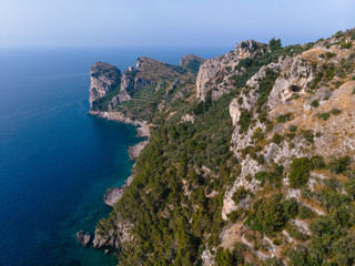 Beautiful aerial view of mountains and sea on sunrise. Marine Park. Trail for active sports, hiking the mountain to a wild beach, Olive trees plantation. Nerano bay, Italy
