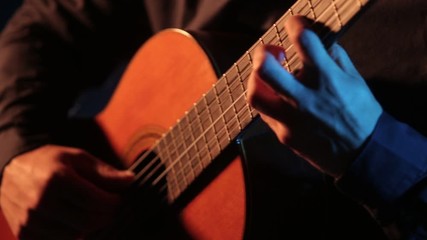 close up of guitar strings, fingerboard and hands, musician playing an acoustic guitar, isolated