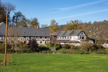 Fototapeta na wymiar Romantic autumn landscape with river Elster with beautifully renovated old farm near the place Neumühle,Elster in Thuringia,Germany a beautiful hiking area