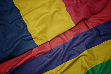 waving colorful flag of mauritius and national flag of chad.