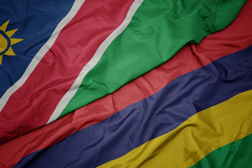 waving colorful flag of mauritius and national flag of namibia.