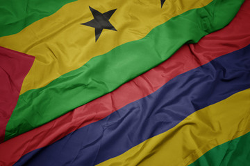 waving colorful flag of mauritius and national flag of sao tome and principe .