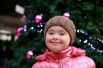 Portrait of young girl on background of the christmas tree