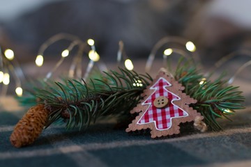 the decoration of the Christmas tree on a checkered background, a cozy blanket on Christmas