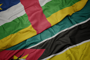 waving colorful flag of mozambique and national flag of central african republic.