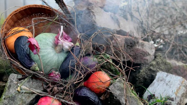 In a pile of stones smoky, stewed vegetables. Still life, subject shooting.
