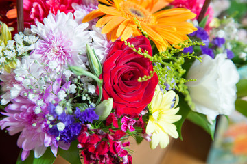 Red flower picture close up in the bouquet. The flower's petal . Bouquet of fresh red, white , orange roses . bouquet of multicolored roses .