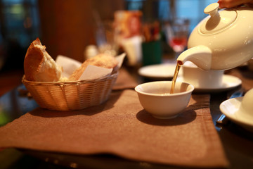 Person pouring tea