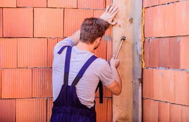 General maintenance and repair workers are hired for maintenance and repair tasks. Use hammer. Worker with hammer brick wall background. Building and construction. Engineer with hammer tool