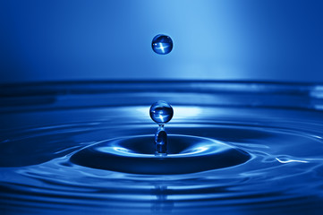 Abstract water background toned in blue classic color 2020, water drops frozen in the air