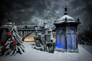 Miniature of winter scene with Christmas houses, train station, trees, covered in snow. Nights scene. New year or Christmas concept. Selective focus