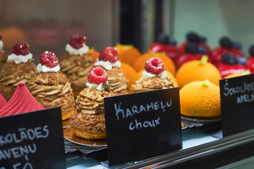 Great variety of fresh baked cakes at good traditional bakery on the city street.
