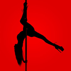 Silhouette of a slender girl while performing dance elements on a pylon. Red background.