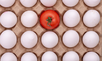white eggs with one red tomato in center