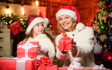 Fototapeta na wymiar Santa, please stop here. Happy family celebrate new year. xmas gift. Open present. merry christmas. mother and daughter love holidays. small child girl with mom in santa hat. Winter shopping sales
