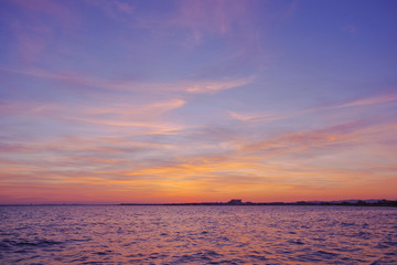 Naklejka na ściany i meble Colorful sunset over the sea. Purple sky.