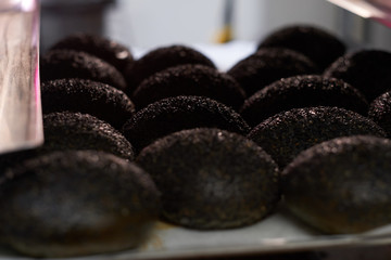 Fresh tasty buns on the palate at busy factory with no one on the photo.