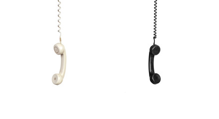 Two vintage phones hanging of a cable