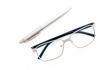 Fashion reading glasses and pen on white background