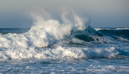 Dangerous wavy ocean with wind waves crashing.