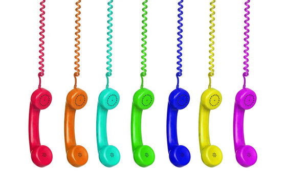 Manu colorful vintage phones hanging of a cable