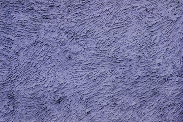 Dark blue texture plastered wall for background. Rough cement wall stucco. Beautiful blue facade stucco background. The exterior of the building. Sand and cement plaster.