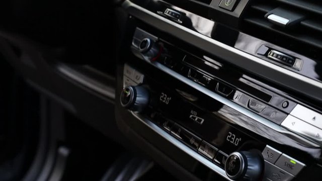 the dashboard is pulled into the brown leather of a premium crossover in dark colors.