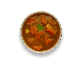 Isolated image of a bowl of delicious hearty winter vegetable soup, in a rustic bowl, with drop shadow.