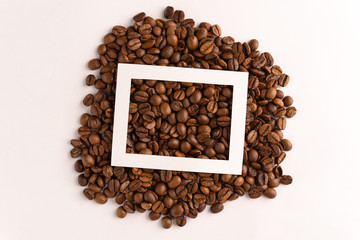 Coffee bean layout with cut out paper frame on white background