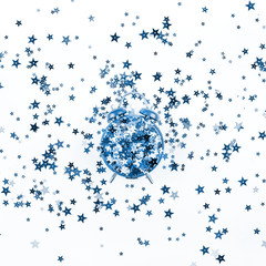 Star confetti with alarm clock concept blue toned