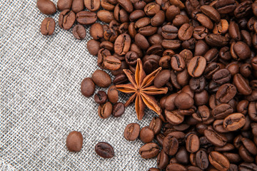 warm roasted coffee beans on burlap top view