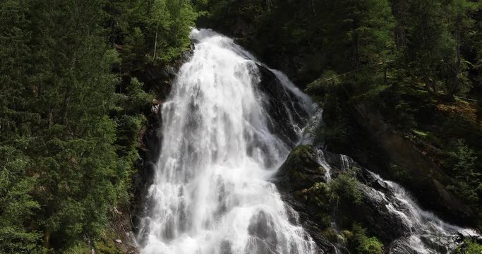 Establishing shot of the Schleierfall (veil fall), a huge waterfall in the Hohe Tauern nature reserve in the Austrian Alps in the valley of Kals am Gro&szlig;glockner.