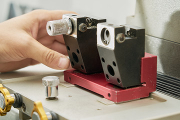 Key duplication machine operated by a locksmith in the process of duplicating a key