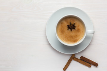 Traditional indian masala tea in a white cup on a white background with copy space