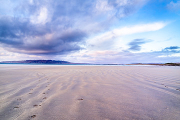 Footprints in the sand at sunset in Portnoo, County Donegal - Ireland