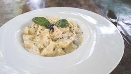 A dish of a pasta with seafood in a white sauce. Close up.